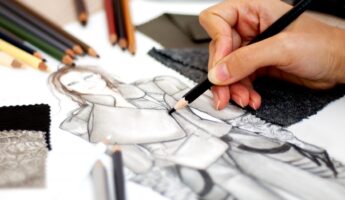 Image of hand drawing a fashionable outfit