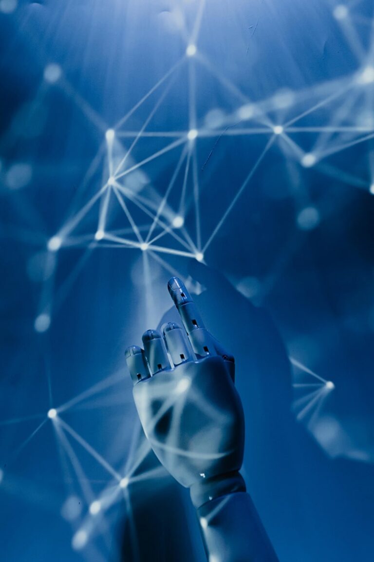 A robotic hand is reaching upward toward glowing interconnected nodes and lines, representing a digital network, all set against a blue background.